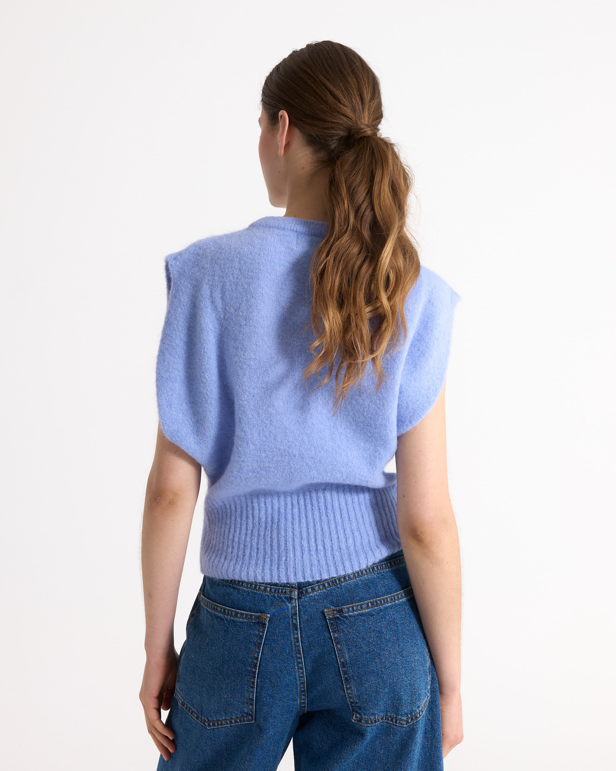 sleeveless sweater, light blue, knitted, ribbed hem, denim jeans