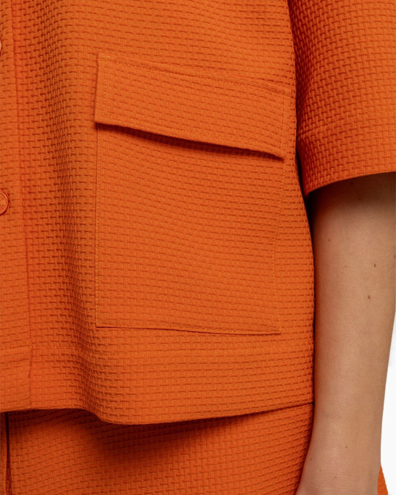 orange, pocket, short sleeve, textured fabric, vest-like top