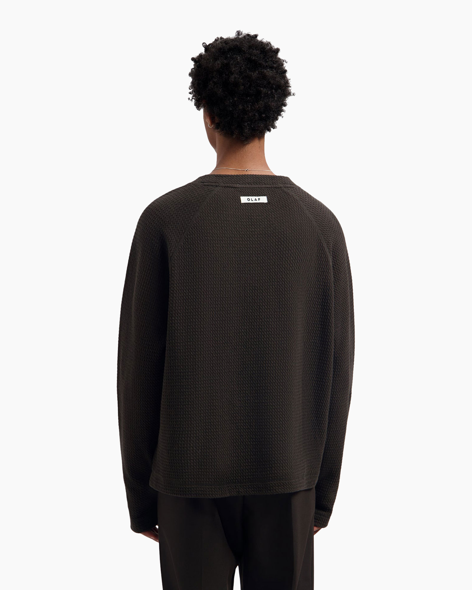 dark sweater, knitted fabric, raglan sleeves, back view, small tag