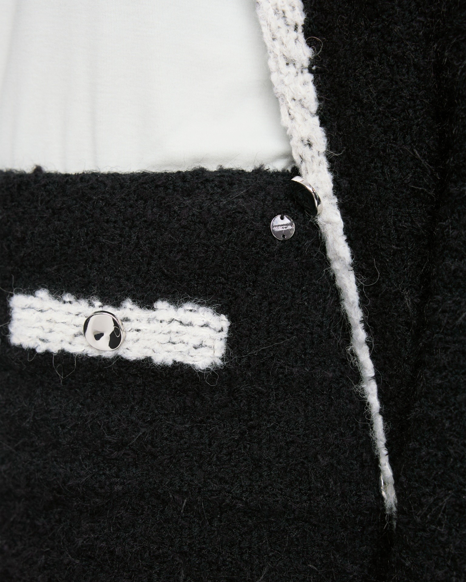 black suit, boucle, white trim, metal buttons, pocket detail