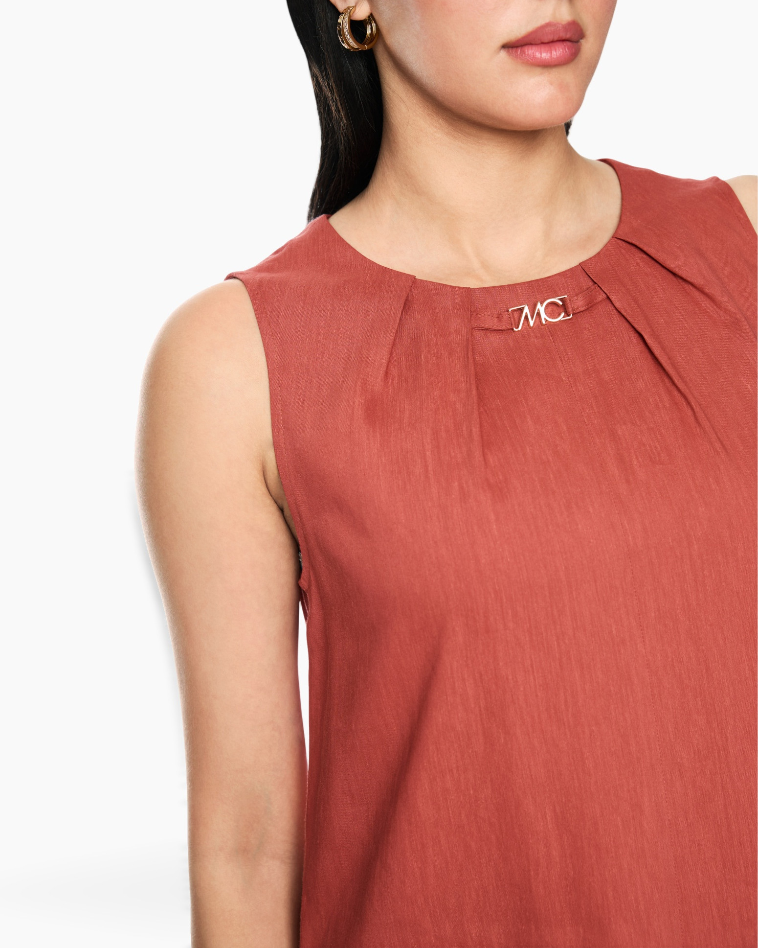 sleeveless top, rust color, pleated neckline, metal logo, high neck