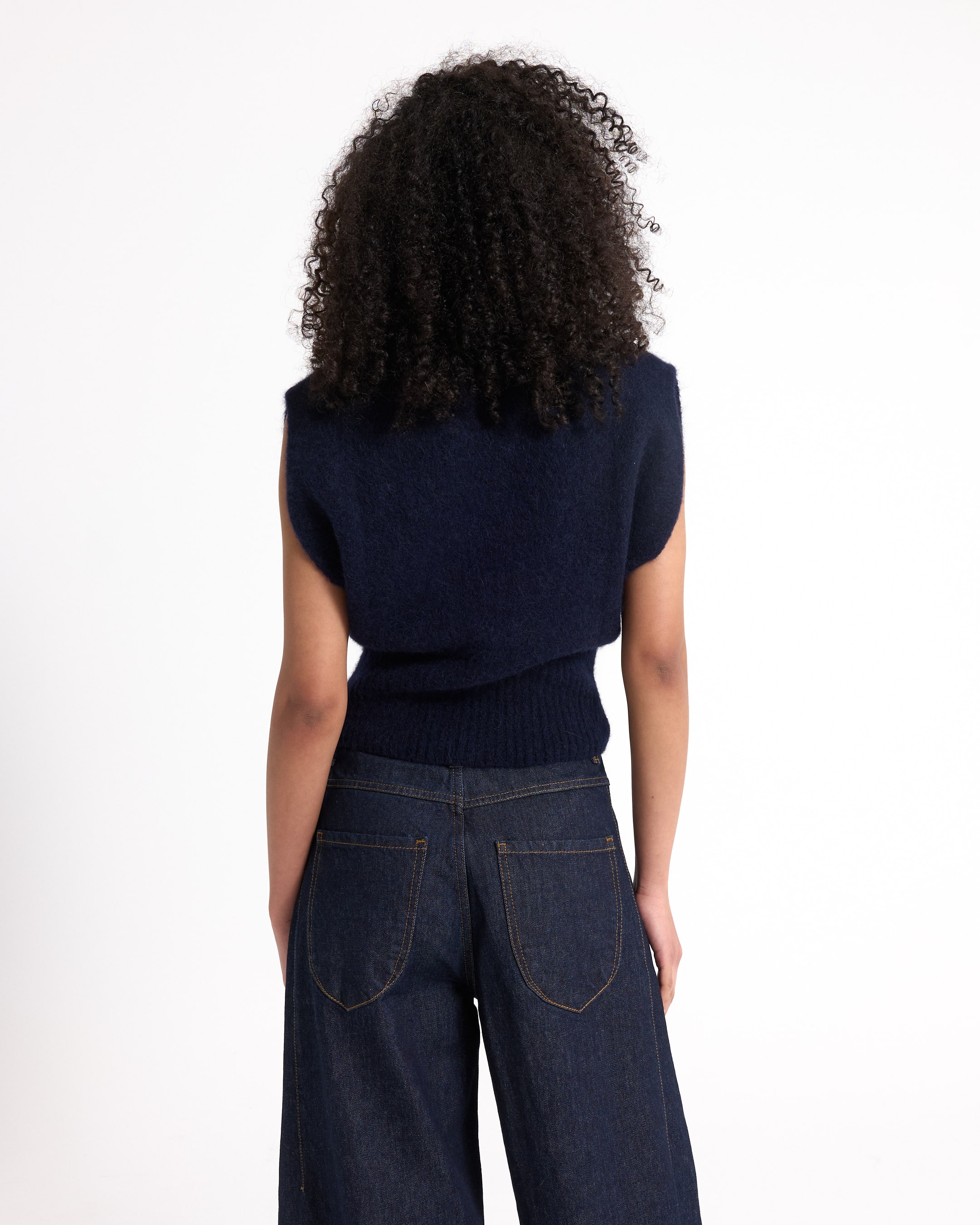 sleeveless,  navy top,  knitwear,  dark jeans,  back view