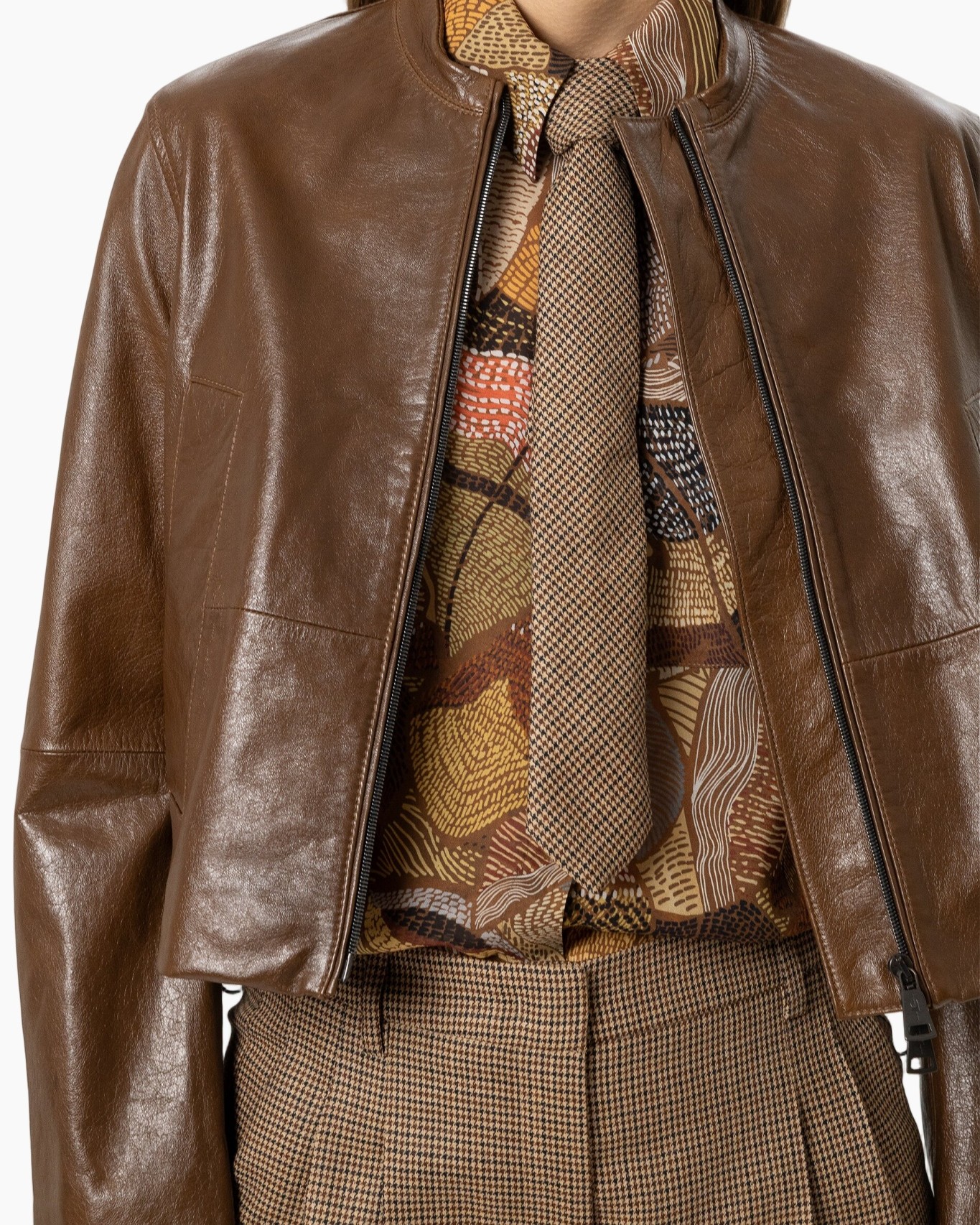 brown leather jacket, biker jacket, brown scarf, patterned blouse, tweed trousers