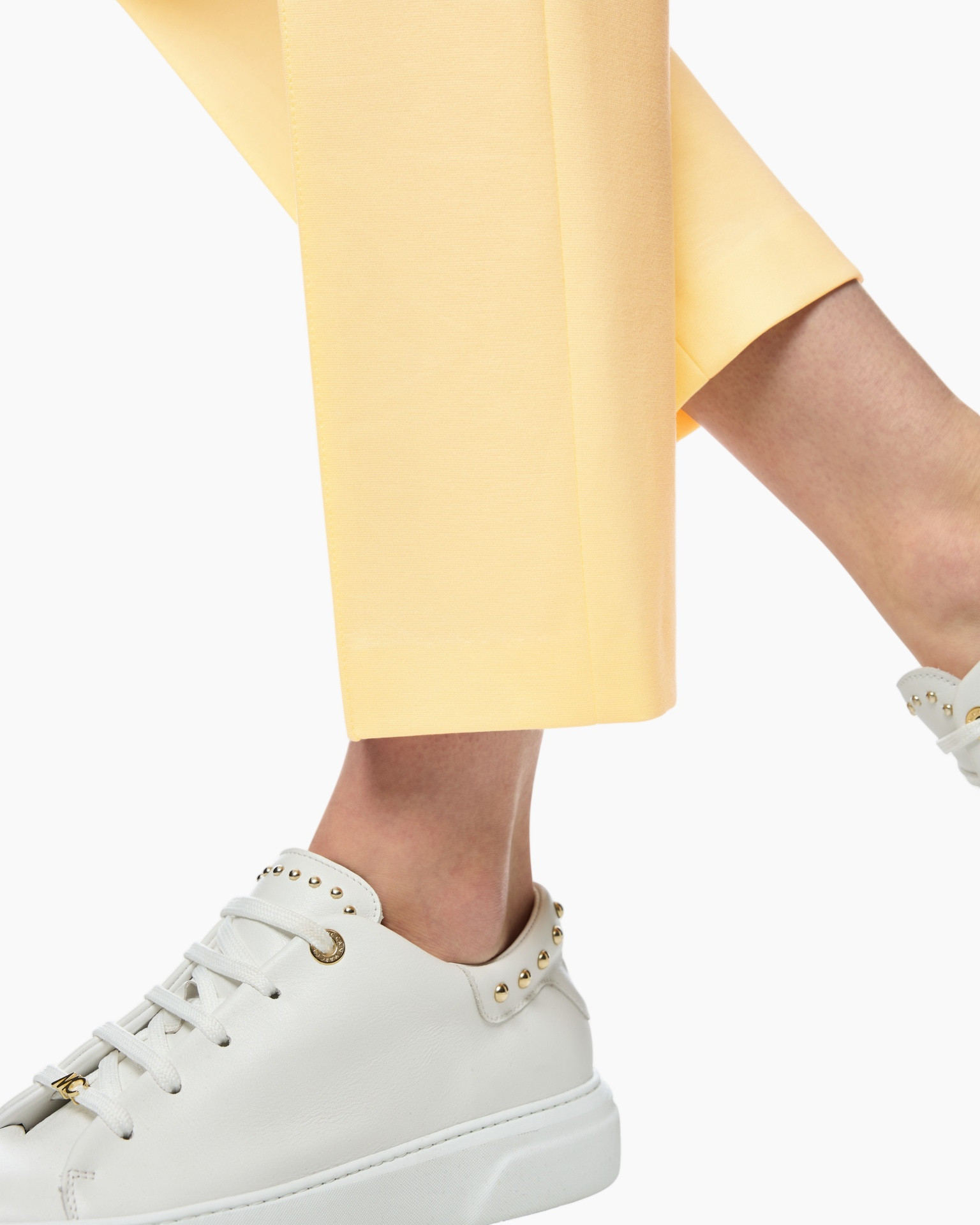 yellow pants, ankle pants, white sneakers, studded details, casual footwear