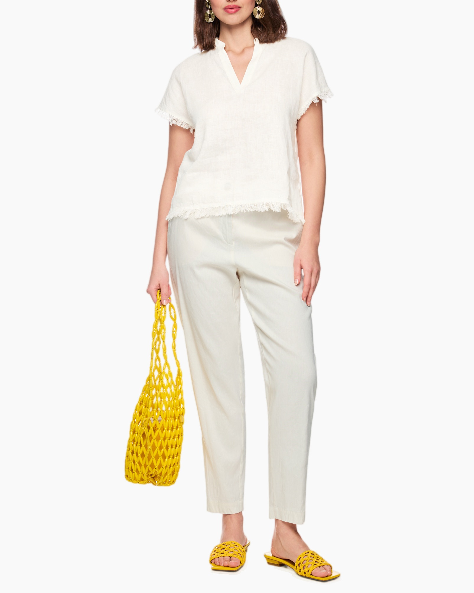 white top, frayed hem, short sleeves, light pants, yellow bag