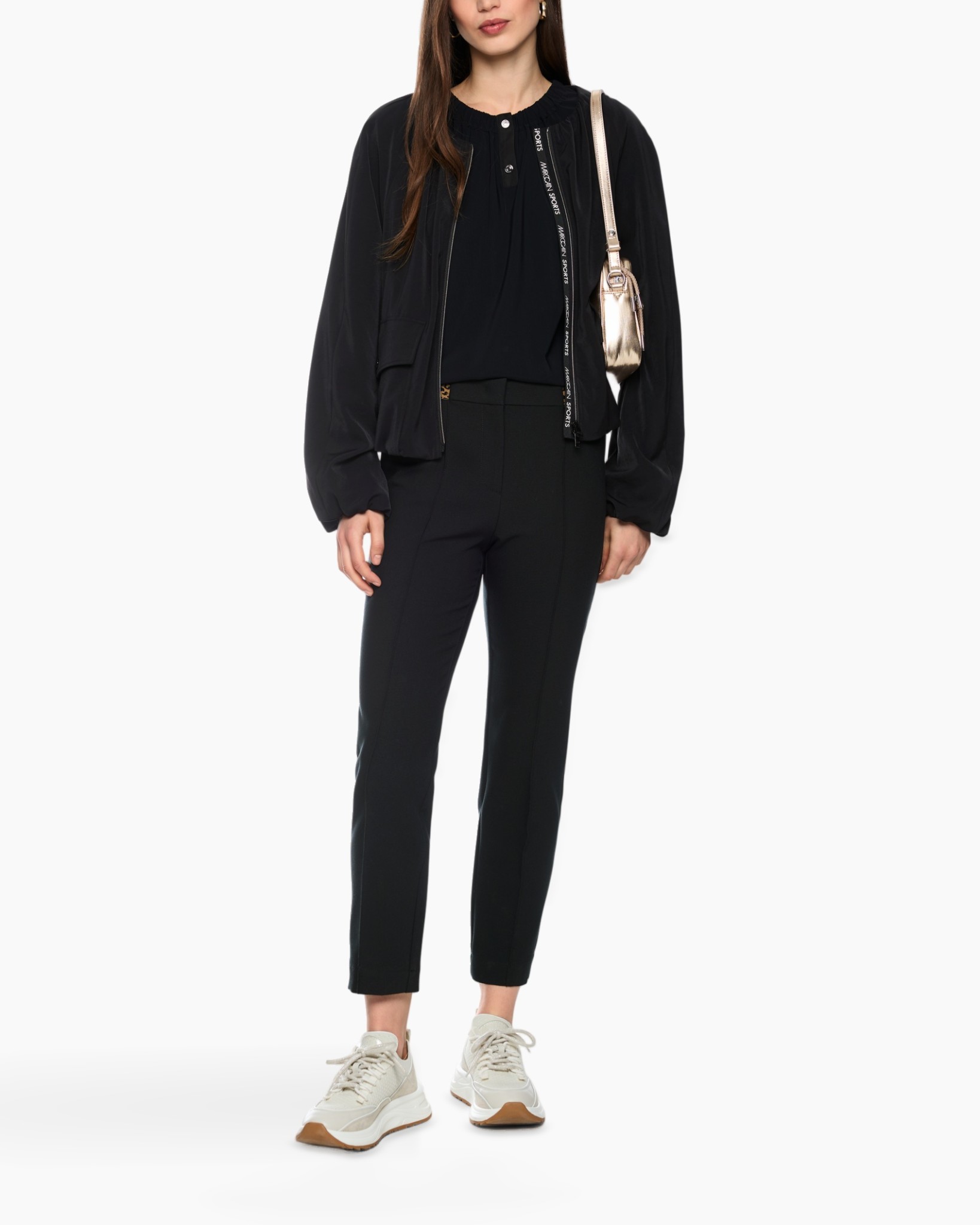black outfit, tunic blouse, slim pants, sneakers, crossbody bag