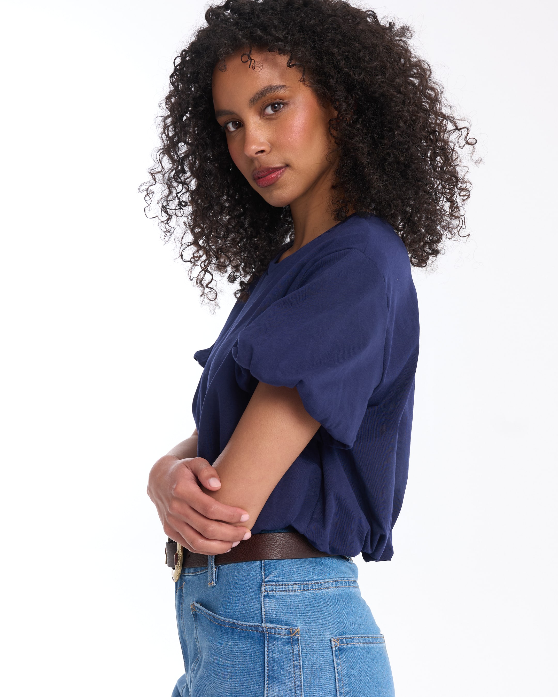 blue top, short sleeves, tucked-in, jeans, brown belt