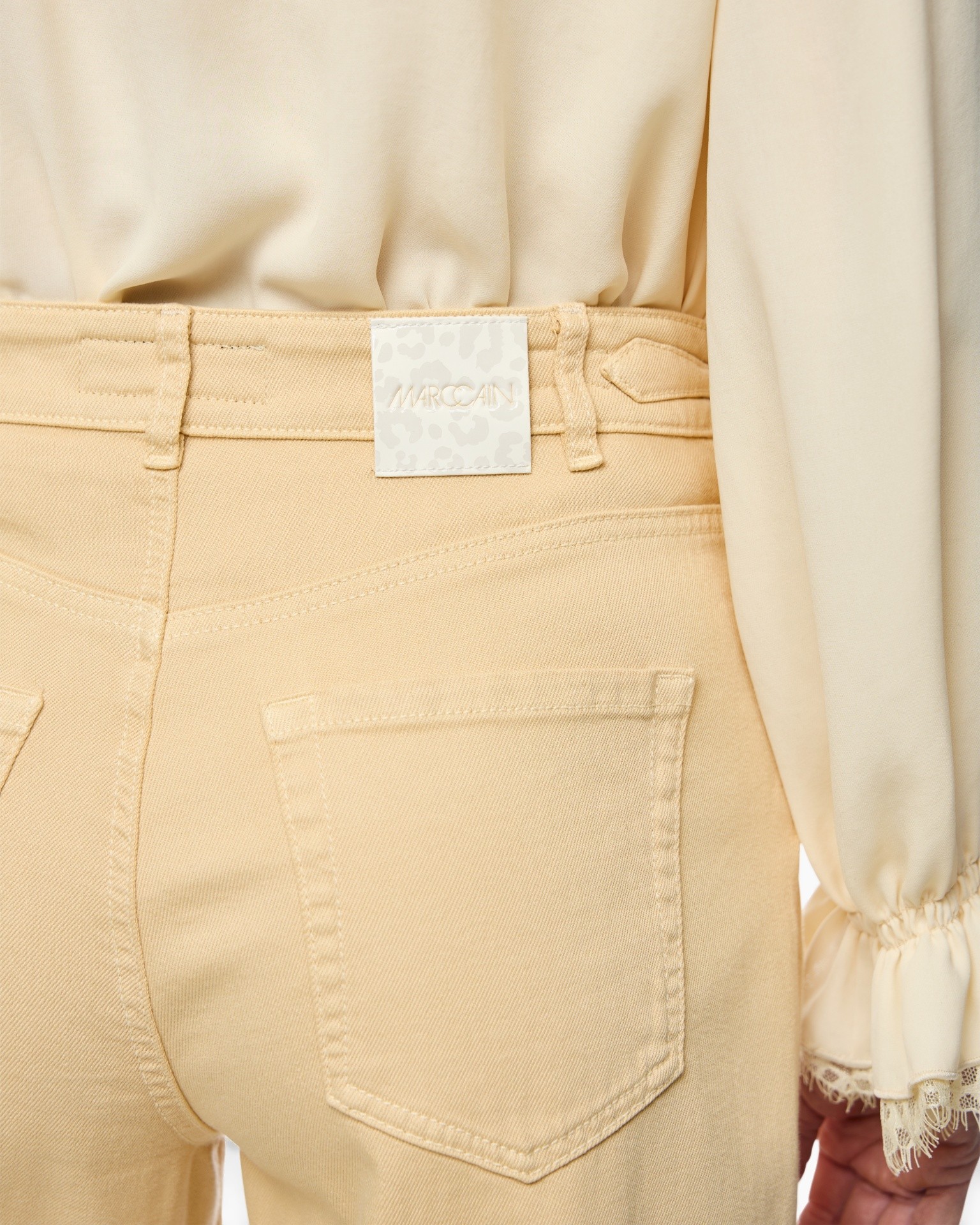 beige pants, back pocket, belt loop, jean style, tag on waist
