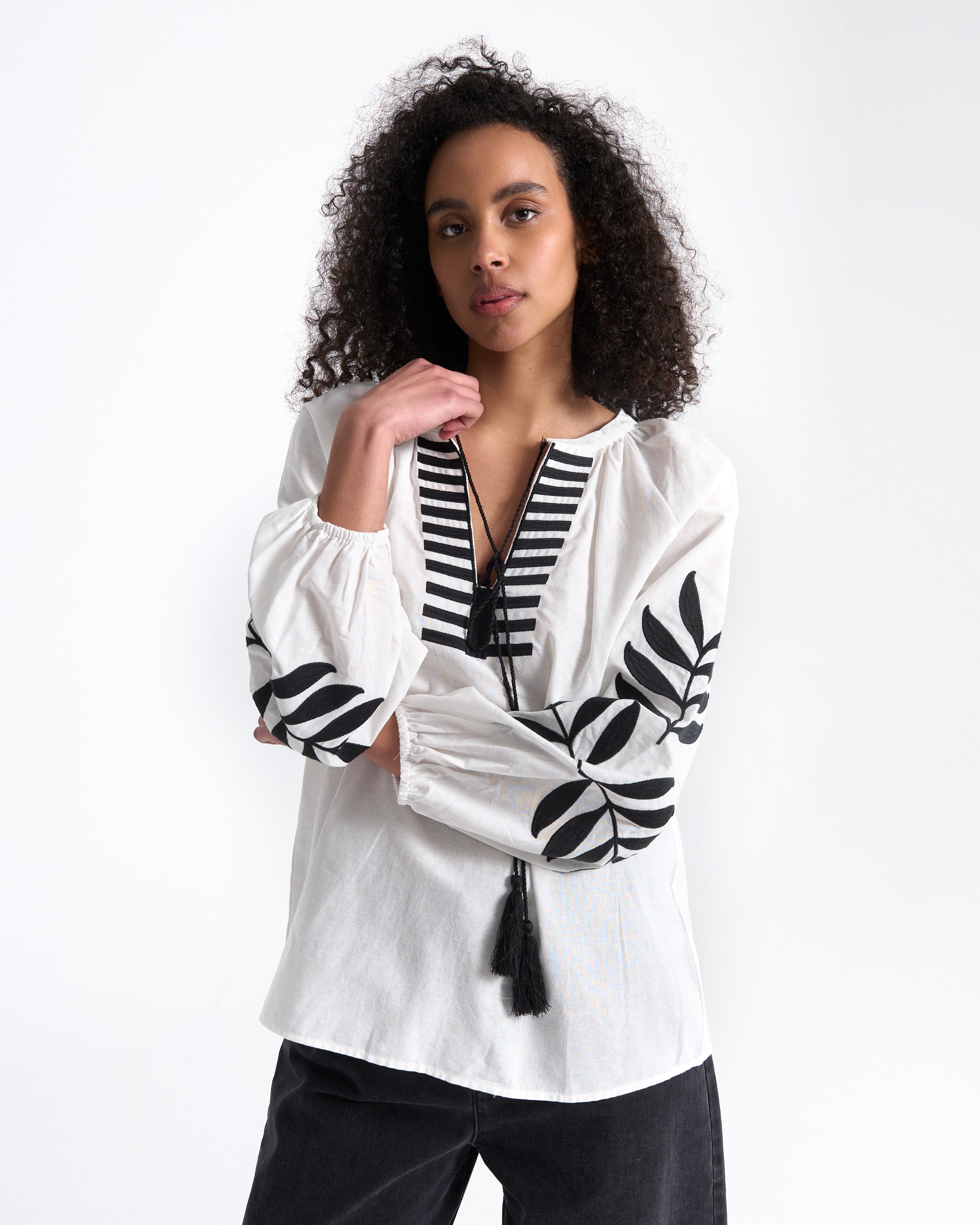 white blouse, embroidered sleeves, black tassels, striped neckline, loose fit