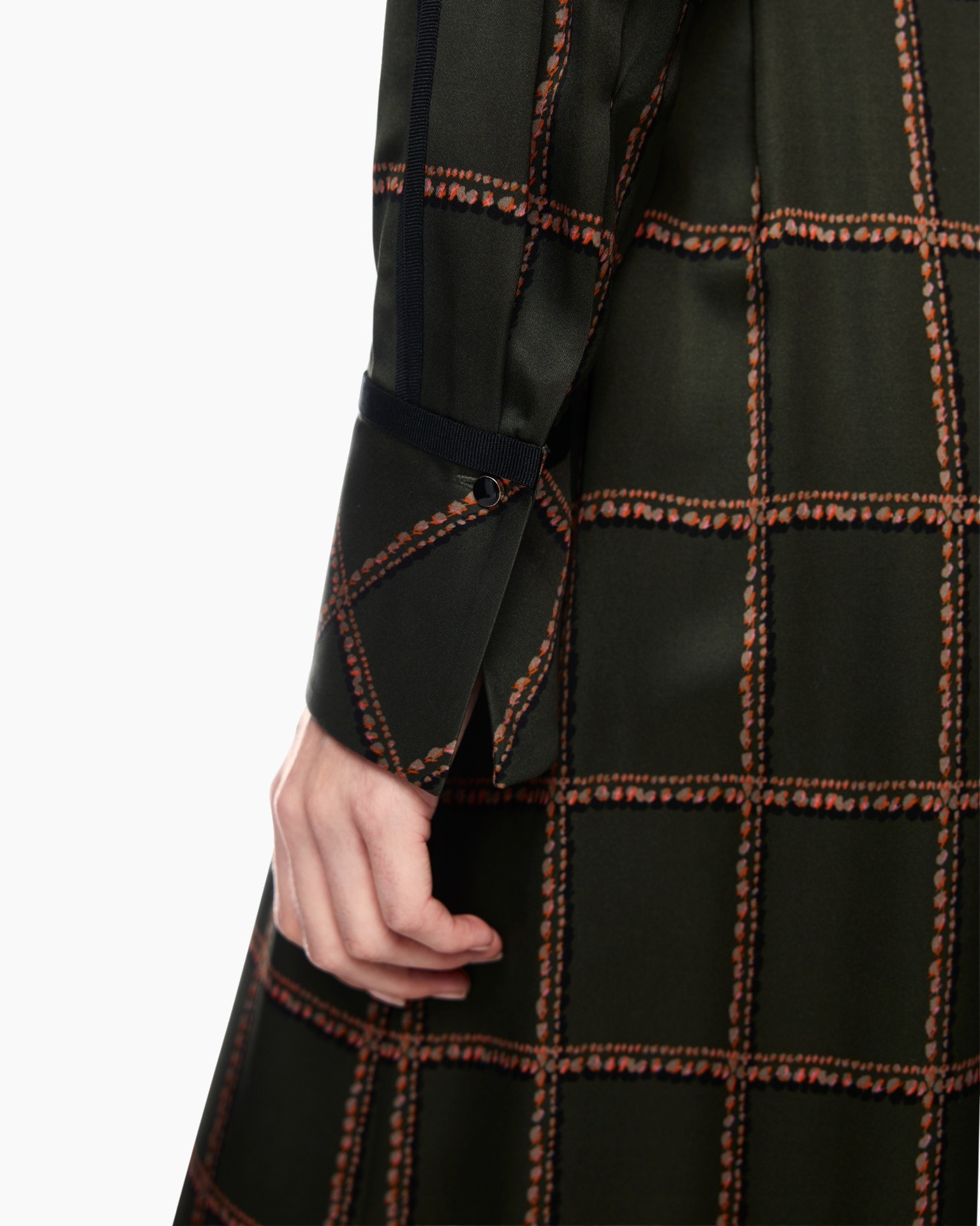 dark green fabric, grid pattern, orange stitching, long sleeve, waist strap