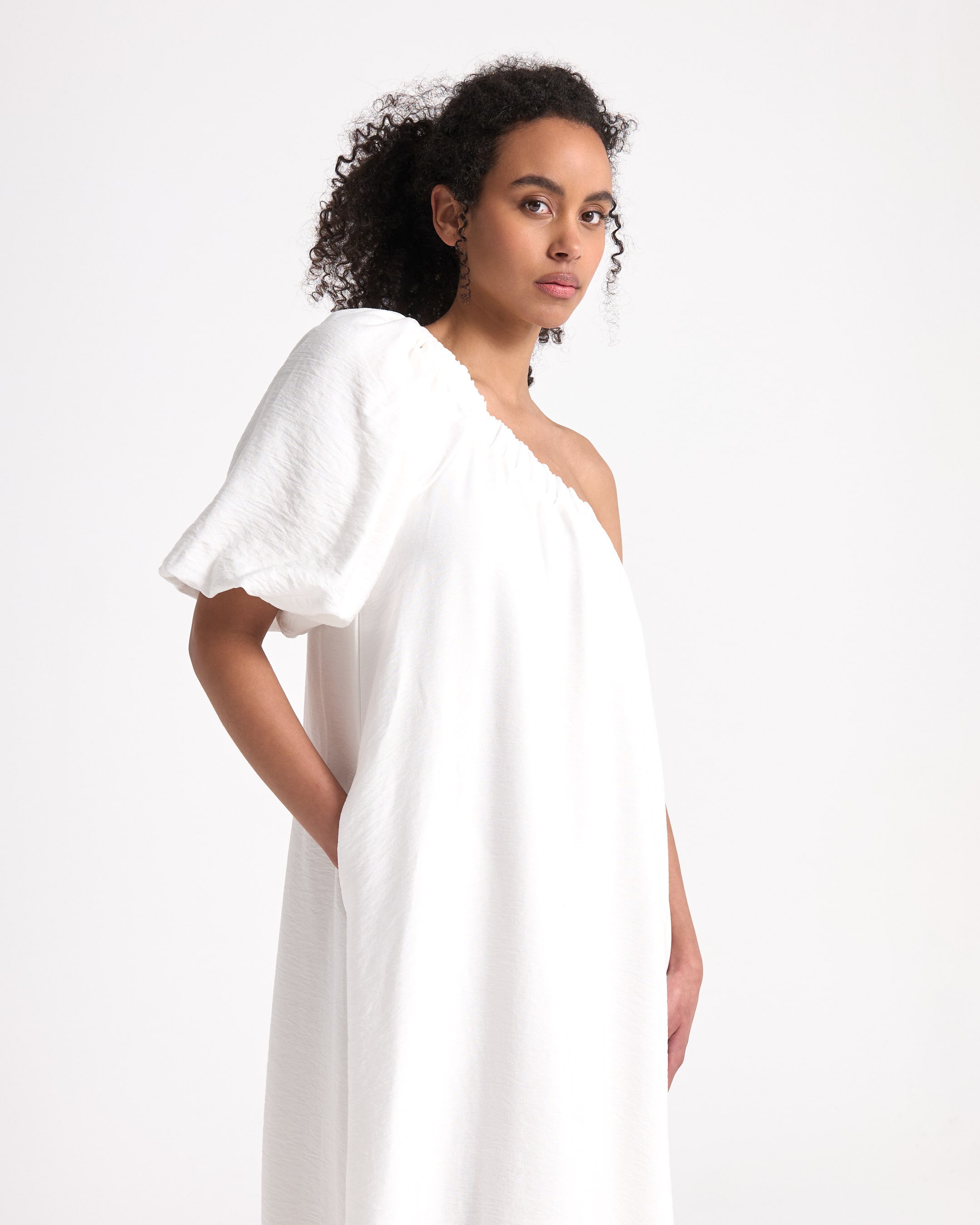 white dress, one-shoulder, maxi dress, muslin fabric, slip-on shoes
