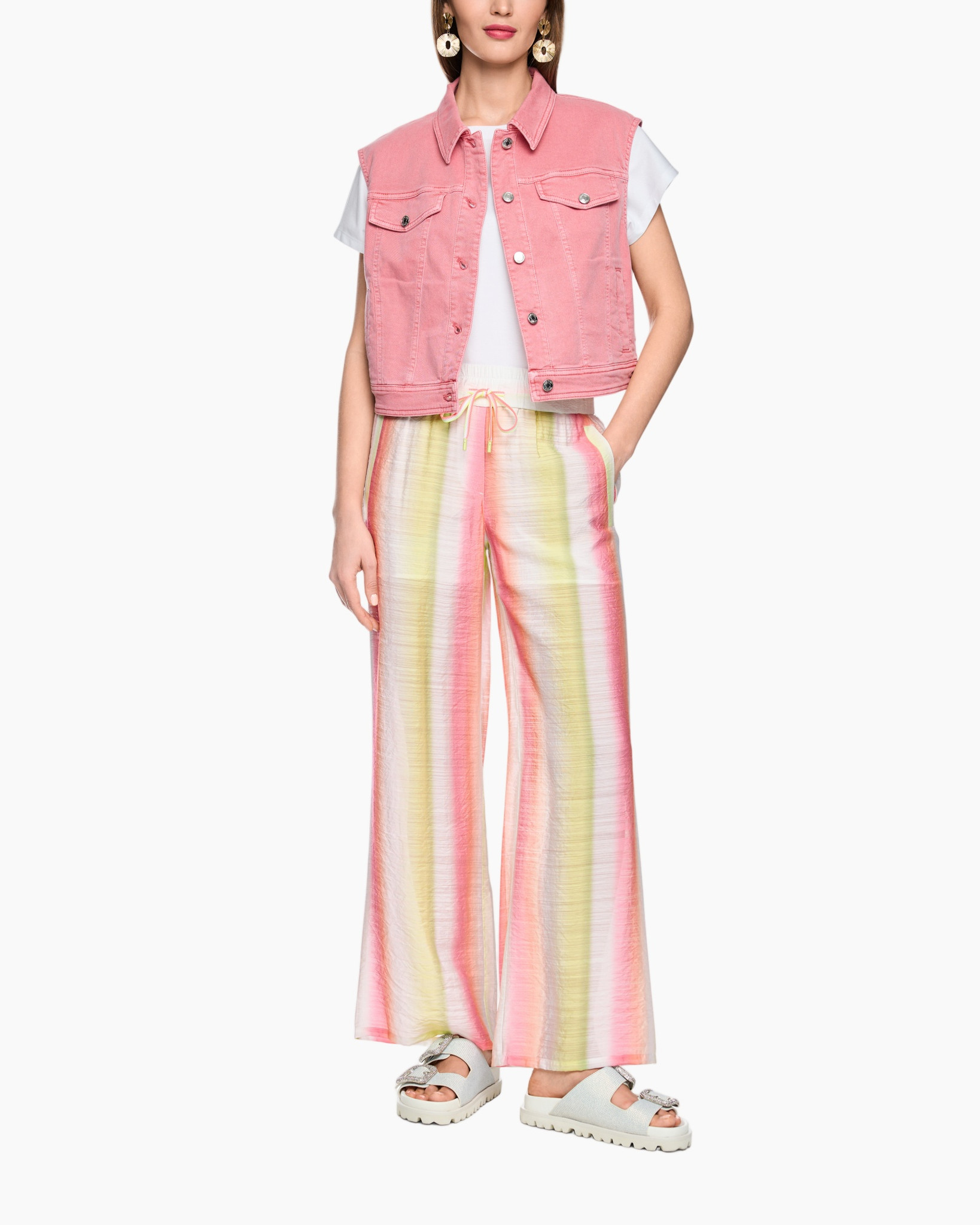 pink denim vest, white t-shirt, colorful striped pants, drawstring waist, sandals
