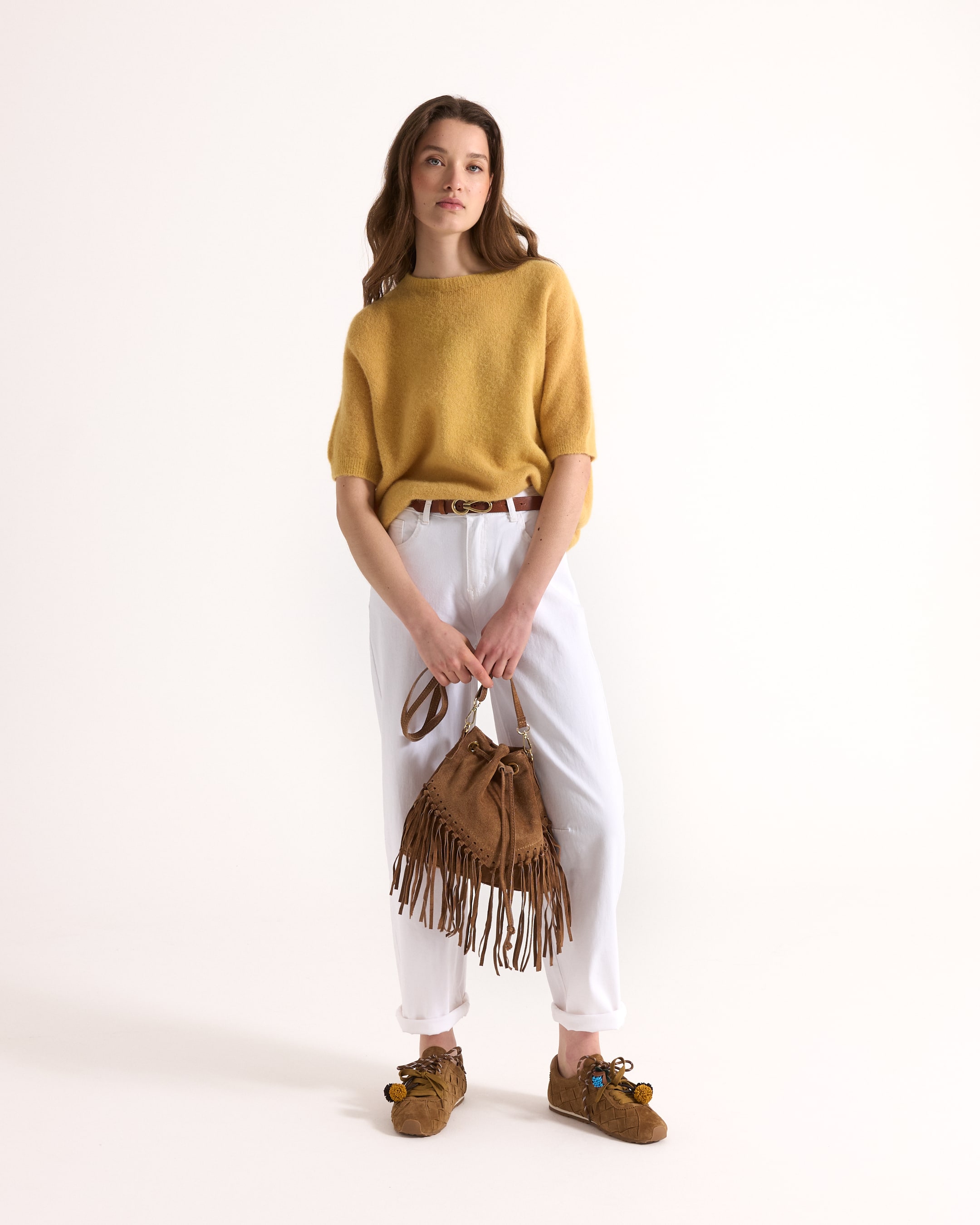 yellow sweater, knit top, white pants, brown fringe bag, brown shoes