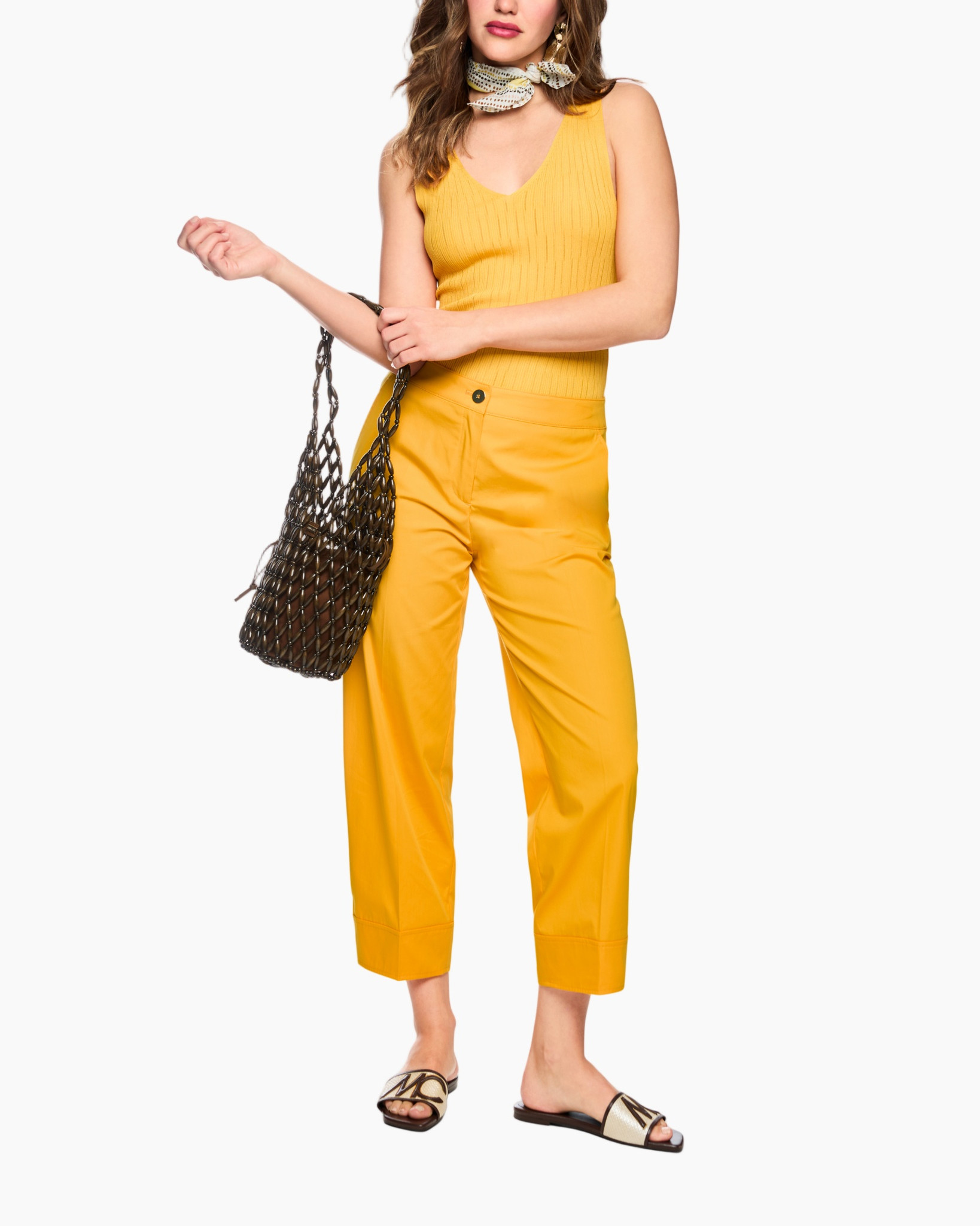 yellow outfit, tank top, cropped pants, thumb necklace, net bag