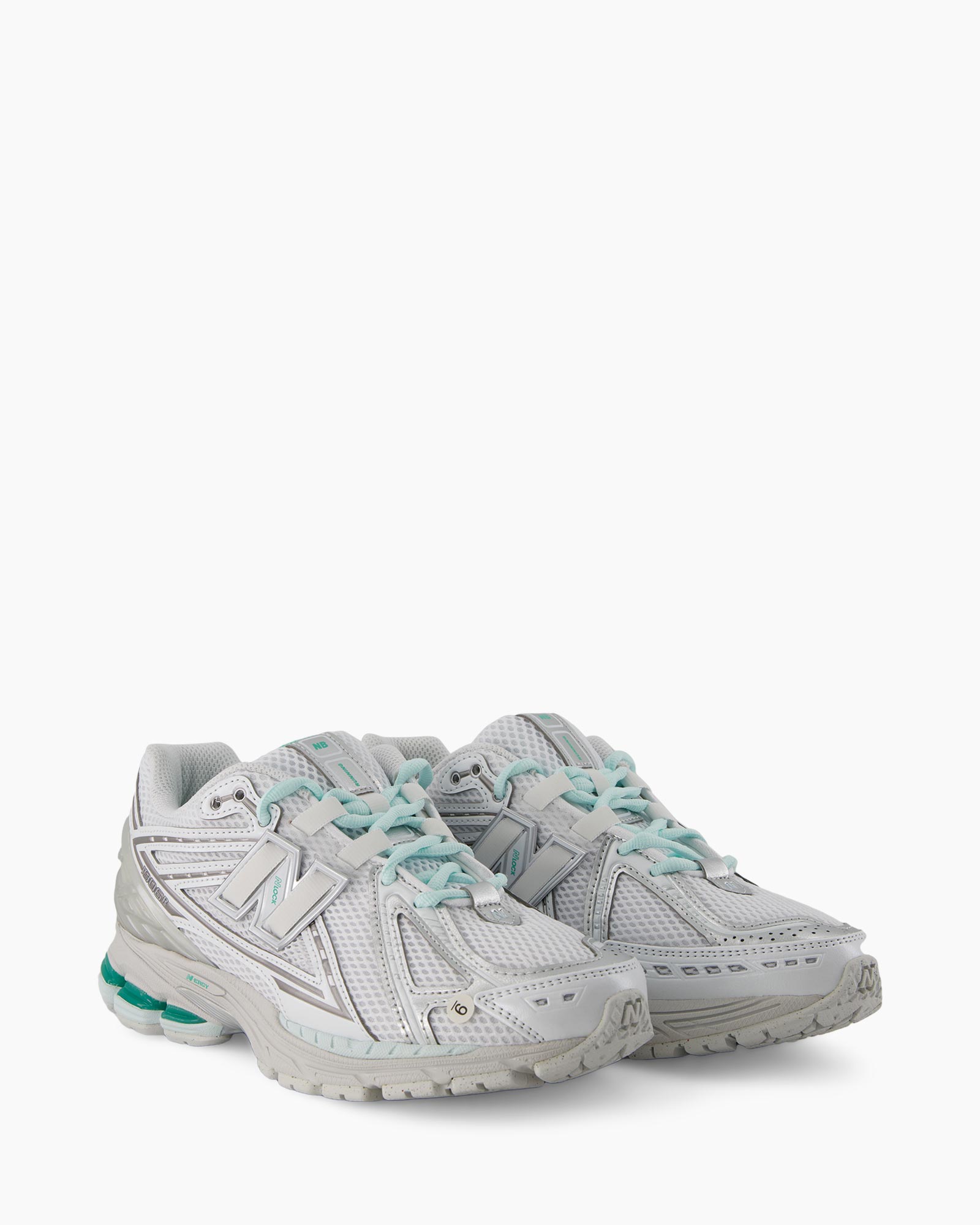 running shoe, white, mesh, trailed sole, light blue green accents
